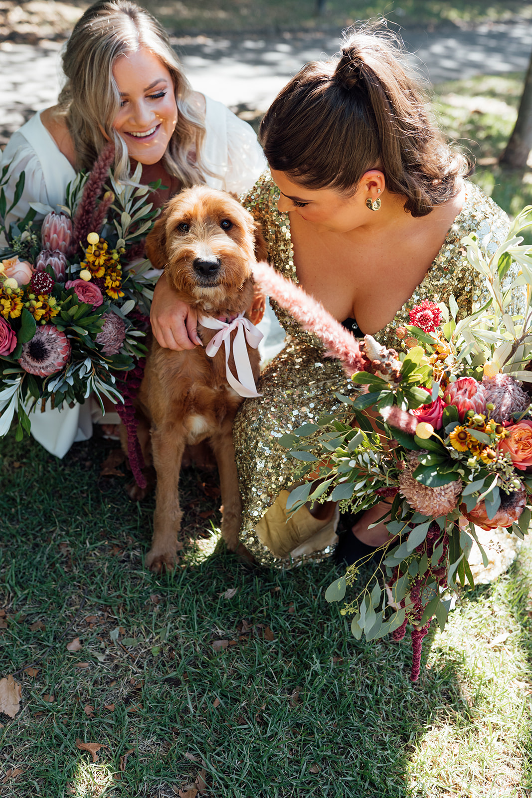 Nikki - Karen Willis Holmes - Sarah & Gabriella- LGBT wedding full of unique and colourful elements, Same sex couple as seen holding their puppies before their ceremony and bride sarah is wearing the classic and simple Nikki gown from the WILD HEARTS collection.