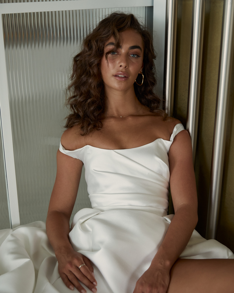 Francis Kirsten is a classic style wedding dress featuring a scoop off shoulder with a high side split detail in Aline style skirt