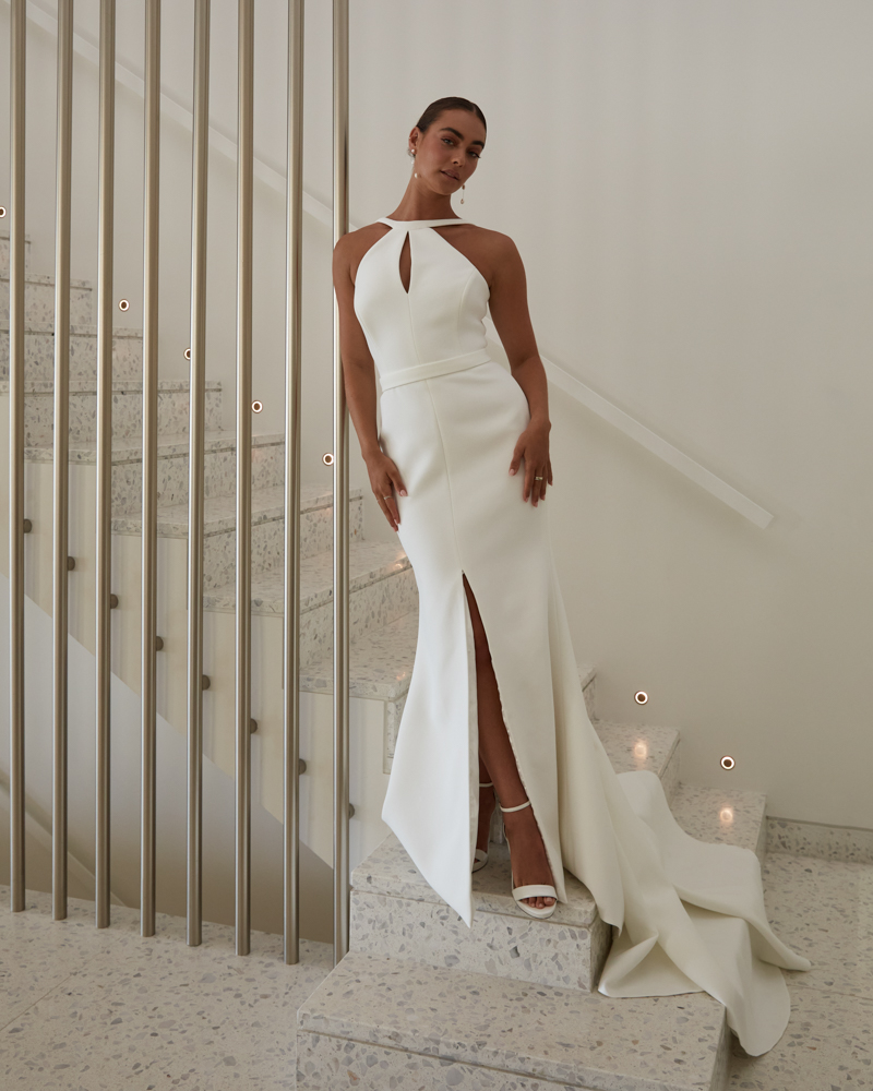 The Frieda wedding dress features a keyhole neckline fitted silhouette with front split detail by Karen Willis Holmes 2023 Bridal Campaign