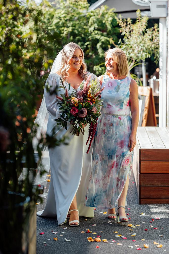 Nikki - Karen Willis Holmes - Sarah & Gabriella- Lgbt wedding, bride sarah is seen wearing a classic, ivory , long sleeve classic wedding dress. featuring V-neckline and soft draping