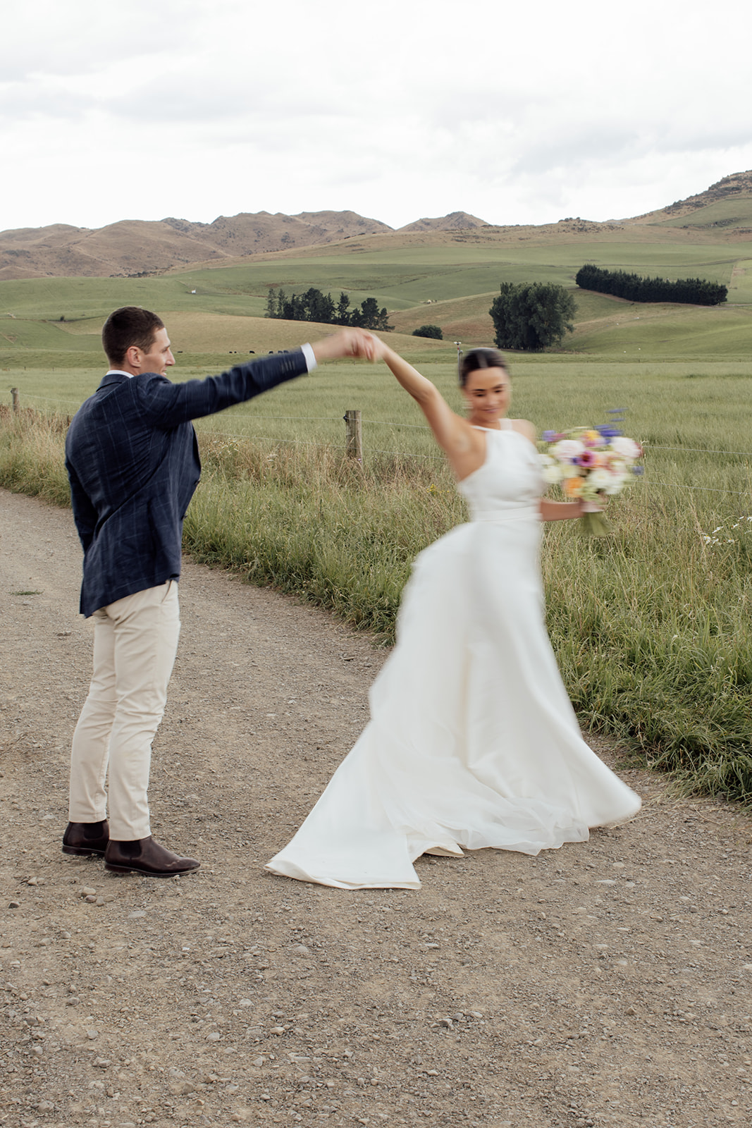 Layne by Karen Willis Holmes-halter neckline wedding dress-Jessica & Tim- Bride and groom are seen taking beautfiul sunset wedding photos, while bride looks like a modern princess in her Layne gown from the BESPOKE collection.