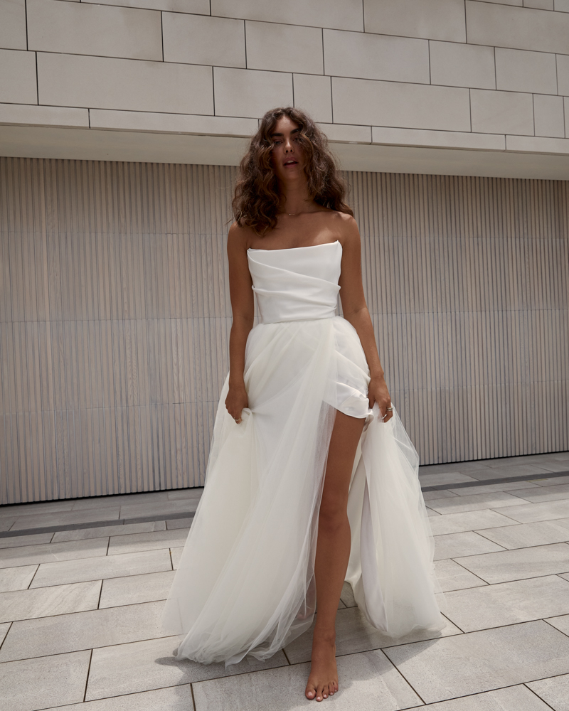 Lou Lou Jules is a romantic Wedding dress with a draped corset bodice featuring a soft Aline, tulle skirt, modern side split by Karen Willis Holmes 2023 Bridal Campaign.