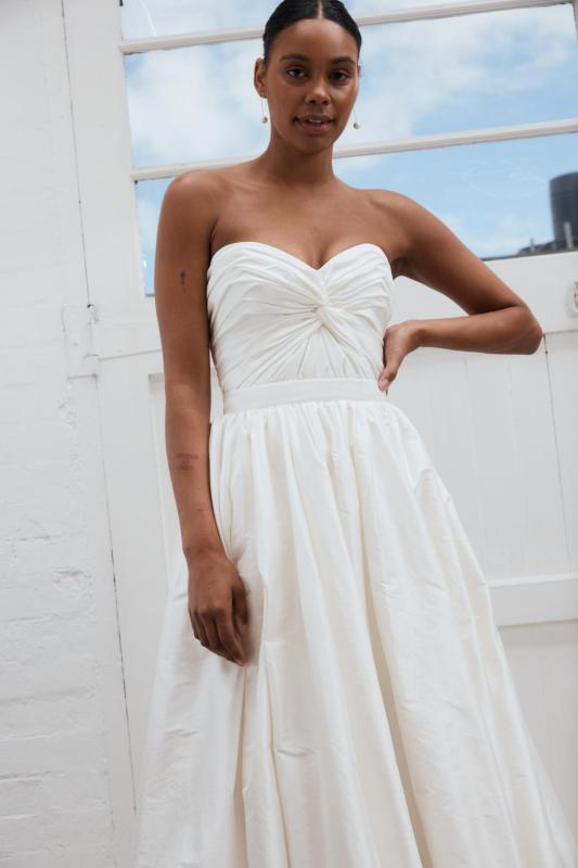 Madelyn Julianne is a modern wedding dress that features a ruched centre twist detail on the bodice and full ballgown style skirt by Karen Willis Holmes from the 2023 Bridal Campaign
