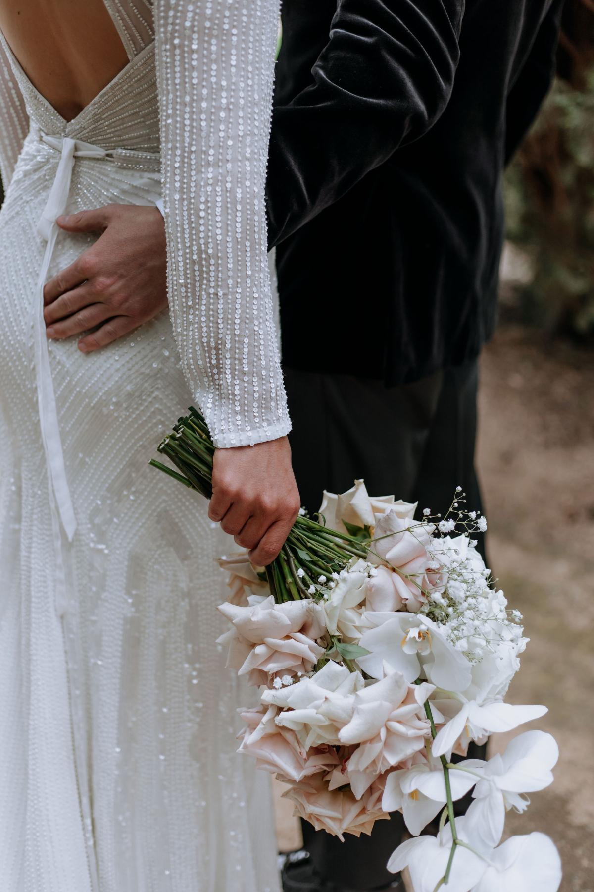 Perry - Karen Willis Homes - Laura & Ben - Bride is holding their classic , off white floral bouquet, with a hint of soft beiges and pinks.