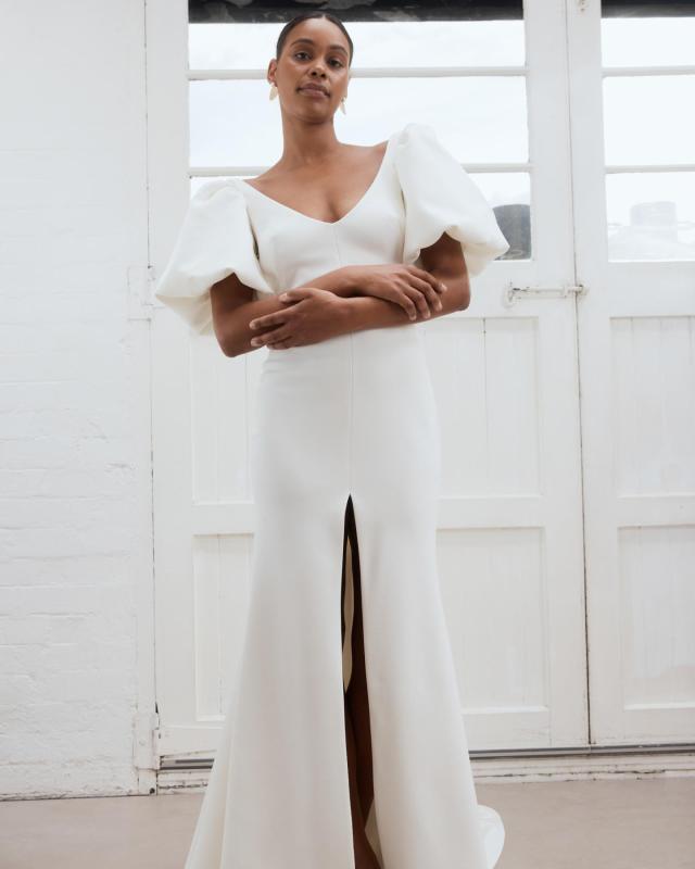 The Shelby wedding dress is a timeless versatile crepe gown featuring a centre split and bubble sleeves for a modern twist. by Karen Willis Holmes 2023 Bridal Campaign.