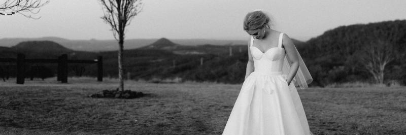 Karen Willis Holmes Bridal Blake & Julianne BESPOKE Gown. A simple minimalist modern ballgown wedding dress with a bustier neckline and full skirt.