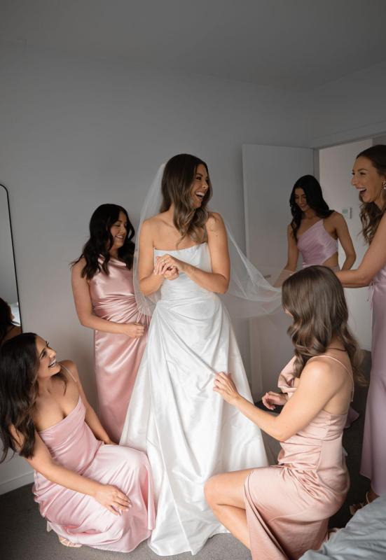 Karen Willis Holmes Real Bride Chloe wearing her Emma gown from the Bespoke Collection with a draped scoop neck bodice with spaghetti straps, A-line skirt and statement split. Chloe had a pink romantic wedding at Hubert Estate photographed by Ashleigh K Weddings.
