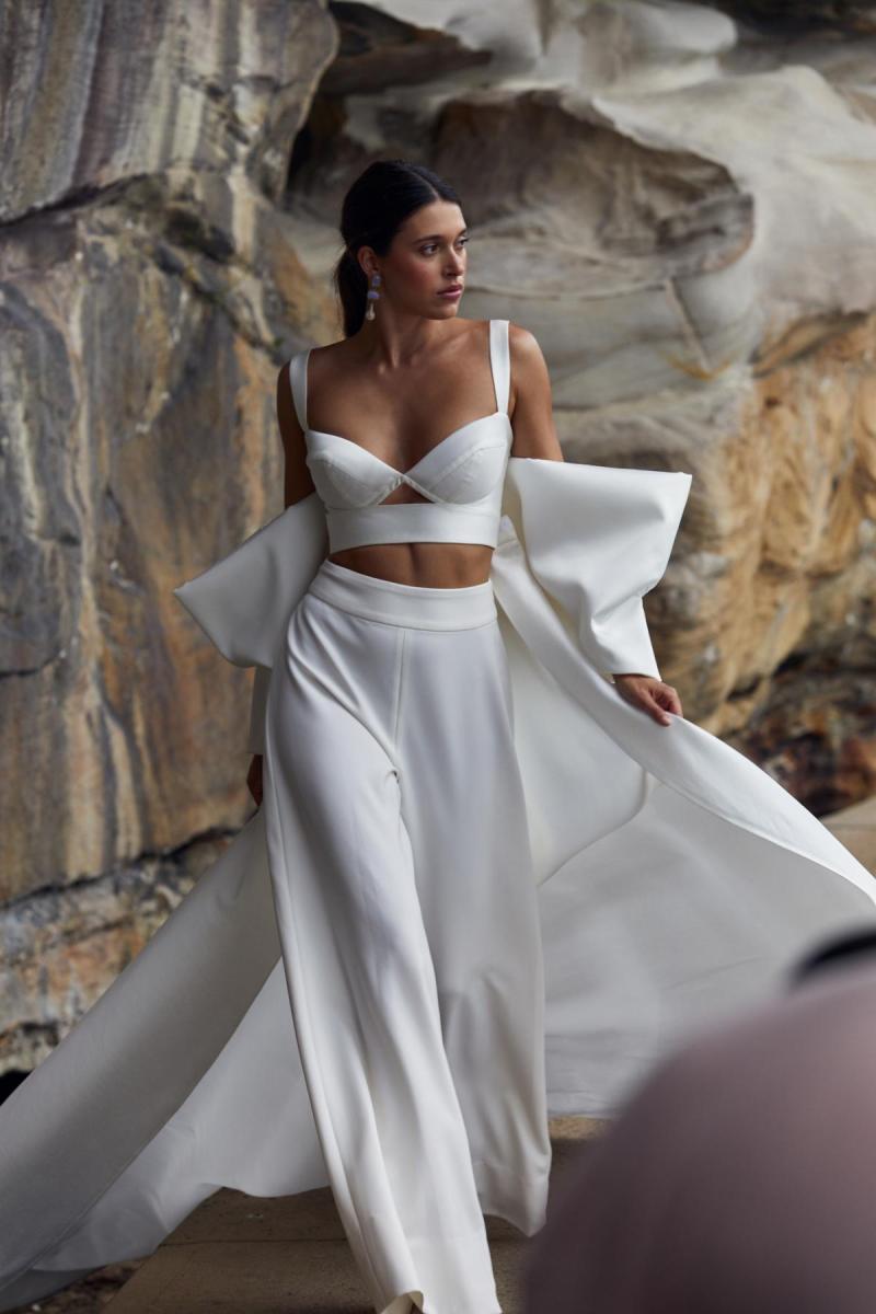 Clara Bralette & Martha pant is a two piece modern bridal look. The Clara bralette features a sweetheart cupped neckline paired with our wide leg Martha pants and statement Bow train.