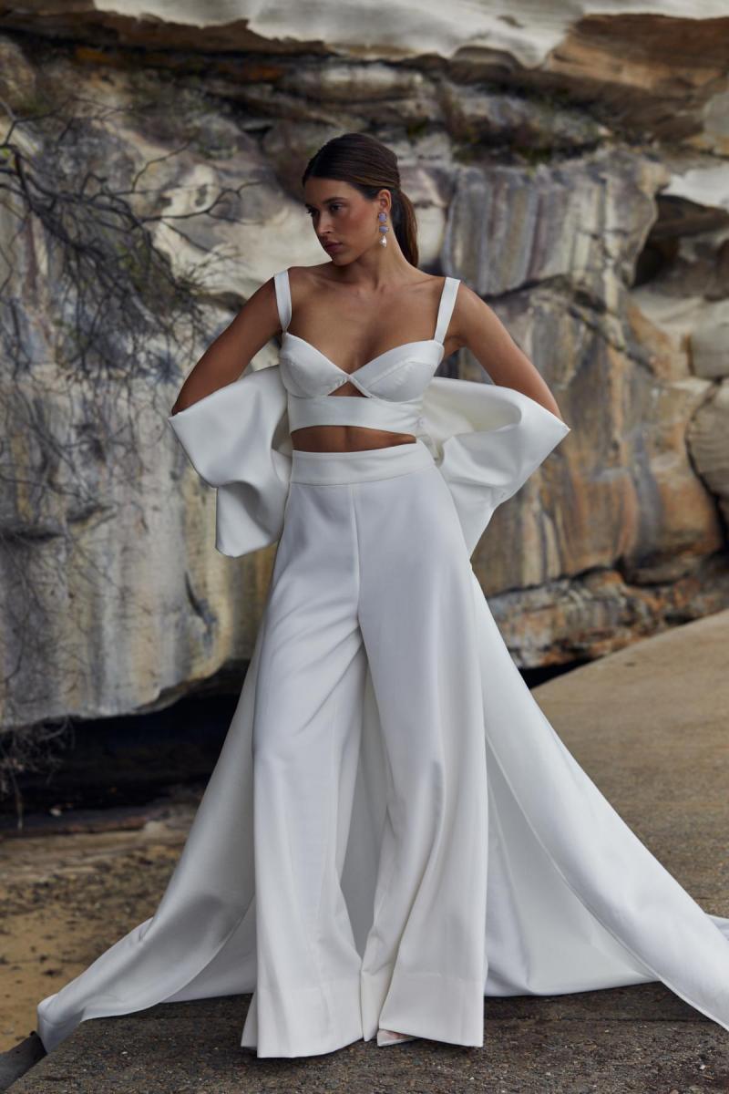 Clara Bralette & Martha pant is a two piece modern bridal look. The Clara bralette features a sweetheart cupped neckline paired with our wide leg Martha pants and statement Bow train.