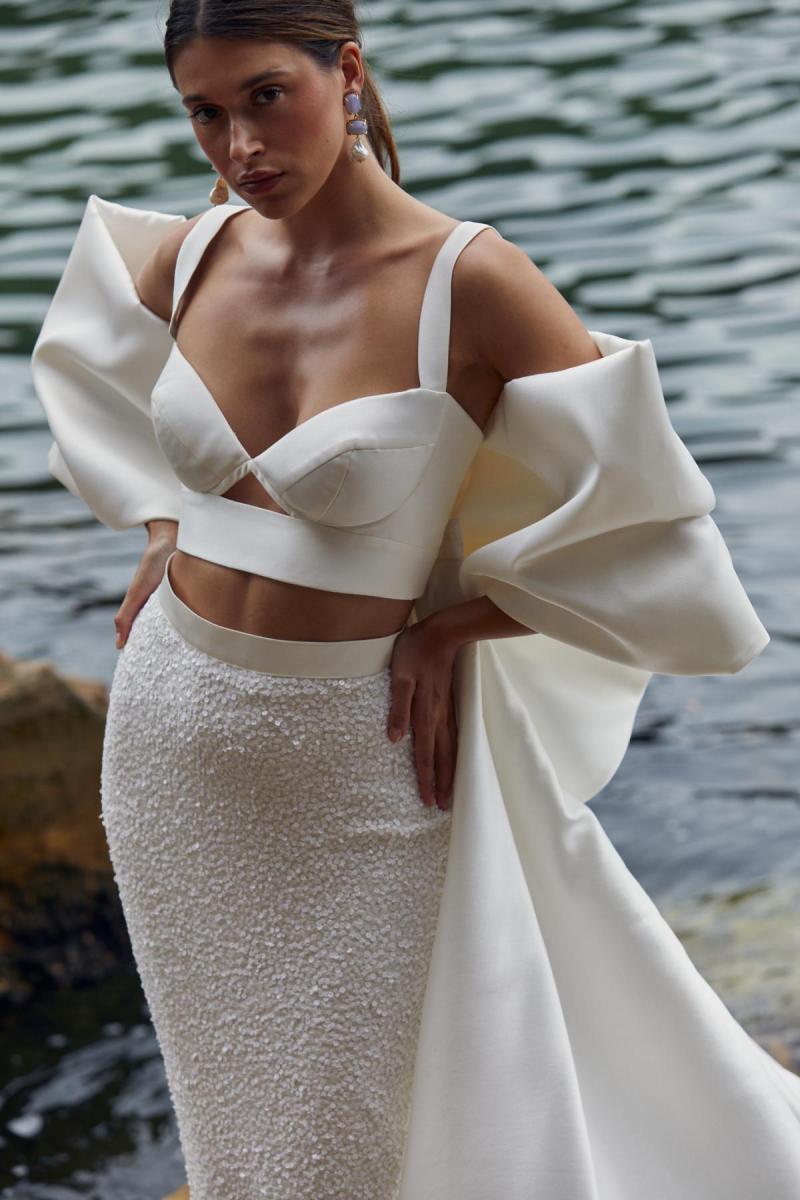 Clara Bralette & Avery is a two piece modern bridal look. The Clara bralette features a sweetheart cupped neckline paired with our fitted beaded Avery skirt and statement Bow train.