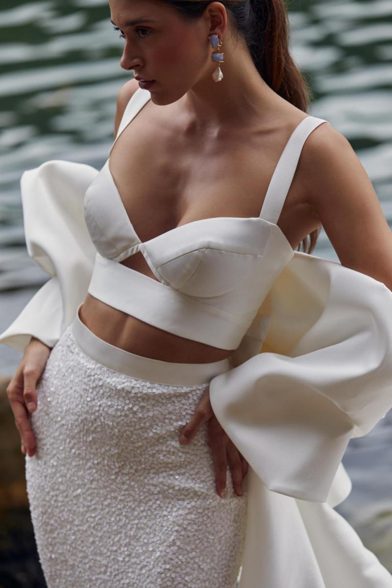 Clara Bralette & Avery is a two piece modern bridal look. The Clara bralette features a sweetheart cupped neckline paired with our fitted beaded Avery skirt and statement Bow train.