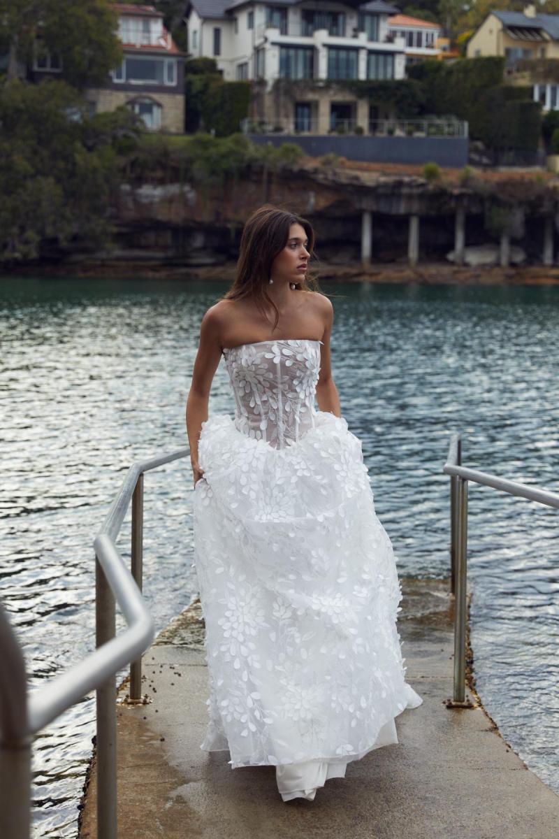 Bailey is a wedding dress for the bride who wants to stand out. Bailey features embroidery that will sparkle and shine at any angle, a corseted long-line basque bodice and ballgown skirt.