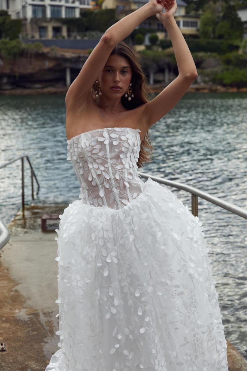 Bailey is a wedding dress for the bride who wants to stand out. Bailey features embroidery that will sparkle and shine at any angle, a corseted long-line basque bodice and ballgown skirt.