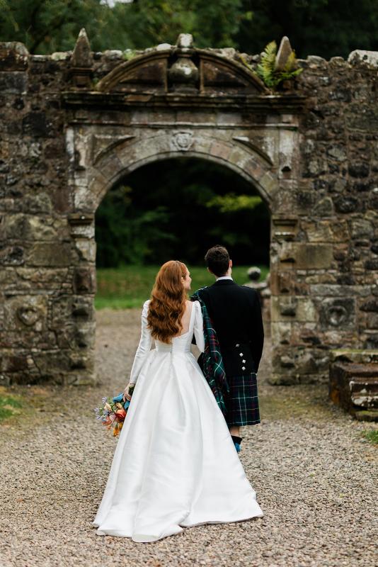 Karen Willis Holmes Real Bride Marcella is wearing her Lou-Lou & Elizabeth gown from the BESPOKE Collection with our beautiful Lilian sleeves. Marcella had a Beautiful Royal wedding at Rowallan Castle Located in Scotland. Photographed by McLellan Photography.