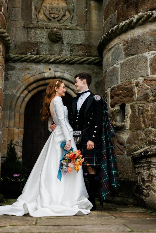 Karen Willis Holmes Real Bride Marcella is wearing her Lou-Lou & Elizabeth gown from the BESPOKE Collection with our beautiful Lilian sleeves. Marcella had a Beautiful Royal wedding at Rowallan Castle Located in Scotland. Photographed by McLellan Photography.