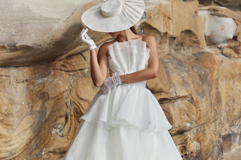 The Phoebe & Mila is the ultimate sculptural wedding dress. The Phoebe Bodice features a stunning hand draped Organza fan paired with the Mila Skirt which features multiple layers of organza.
