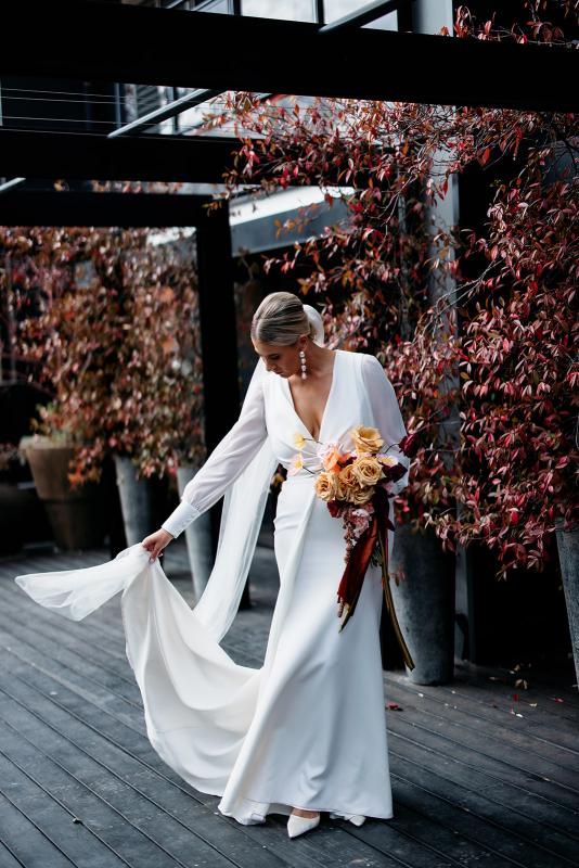 Karen Willis Holmes Real Bride Bec wearing her crepe wrap style Olive wedding gown from the Elope Collection with statement sleeves finished with a button cuff and open low back to her modern Australian wedding featured in Hello May Magazine Real Wedding Special.