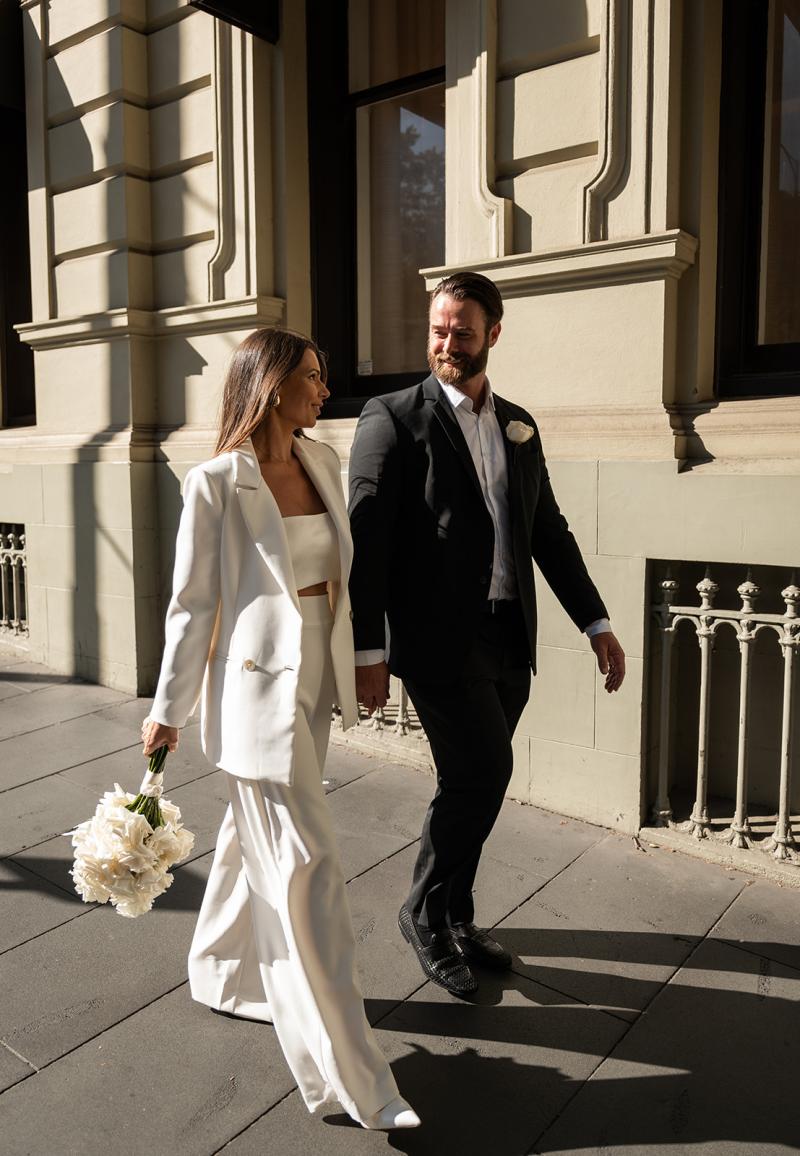 Karen Willis Holmes Real Bride Louise wearing her modern two piece bridal suit set. The Charlie Jacket & Danielle Pants from KWH Bridal's Elope Collection. Louise & Kalim had their registry Elopement ceremony in Melbourne CBD at the Old Treasury Building.