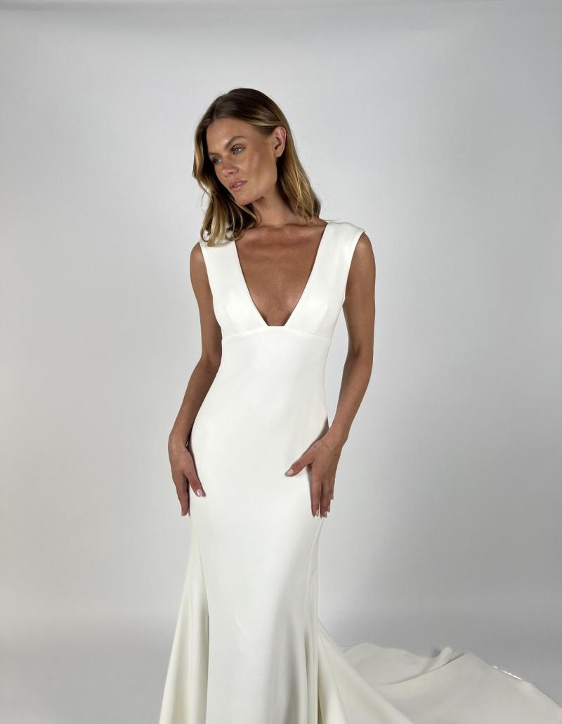 Alana is the gown for the bride who loves simplicity with that hint of drama. The statement plunge neck line, paired with an open back allows you to show off while remaining modern and timeless. Our Heavy Crepe shows your figure without clinging, and its matte and textured look