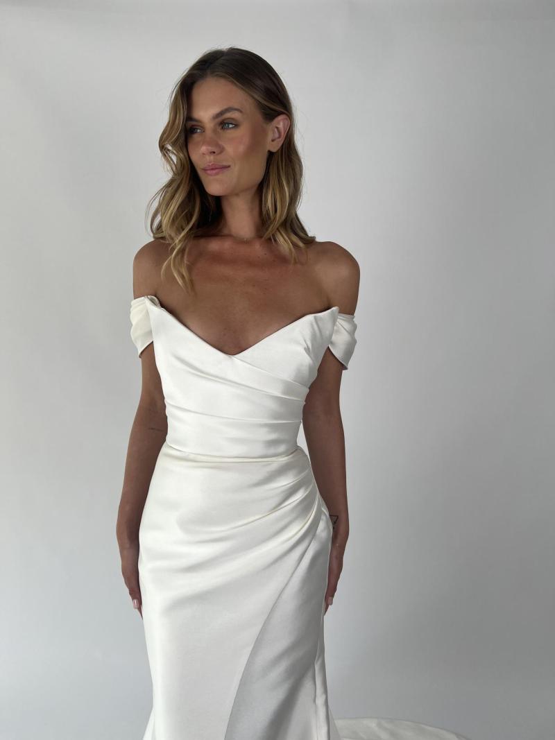 The Alissa & Emily wedding dress by KWH Bridal is for the dreamy bride. The Alissa Bodice features stunning hand draping, with a plunging pointed neckline to highlight your décolletage. The Emily skirt is a fit and flare draped skirt with an elegant split