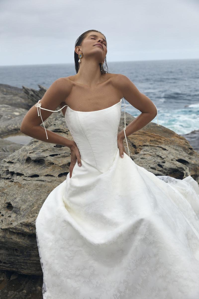 The Bernice Basque & Amelia wedding dress from KWH Bridal - Karen Willis Holmes - Scoop neckline basque wedding dress with A-line skirt with pockets in a Mikado fabric topped with burnout floral pattern organza