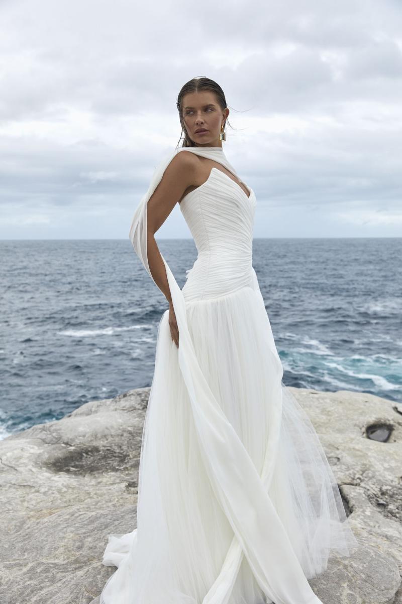 The Capri wedding dress from KWH BRIDAL – Karen Willis Holmes – Drop waist draped tulle mermaid princess gown with peaked bodice cups styled with a long scarf