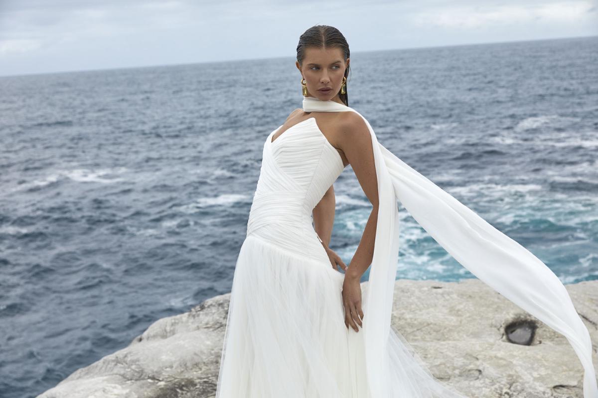 The Capri wedding dress from KWH BRIDAL – Karen Willis Holmes – Drop waist draped tulle mermaid princess gown with peaked bodice cups styled with a long scarf