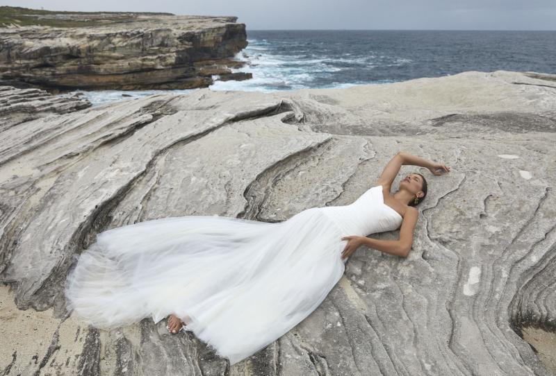 The Capri wedding dress from KWH BRIDAL – Karen Willis Holmes – Drop waist draped tulle mermaid princess gown with peaked bodice cups styled with a long scarf