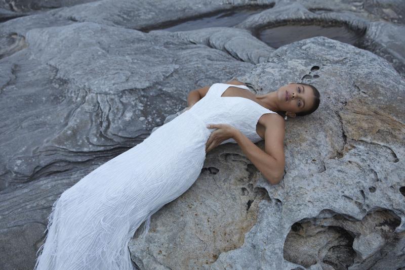 The Geneveive wedding dress from KWH Bridal - Karen Willis Holmes - V-neck beaded wedding dress with fit and flare skirt with feather detail