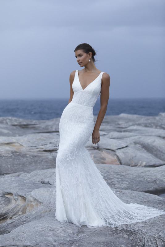 The Geneveive wedding dress from KWH Bridal - Karen Willis Holmes - V-neck beaded wedding dress with fit and flare skirt with feather detail