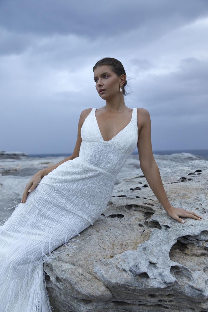 The Geneveive wedding dress from KWH Bridal - Karen Willis Holmes - V-neck beaded wedding dress with fit and flare skirt with feather detail