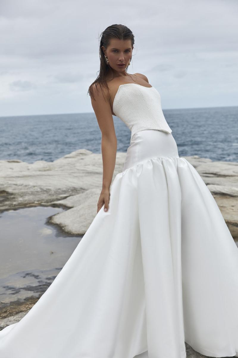 The Raine Dip & Adrianna wedding dress from KWH BRIDAL – Karen Willis Holmes - Basque waist beaded bodice with drop waist princess skirt with pockets & split