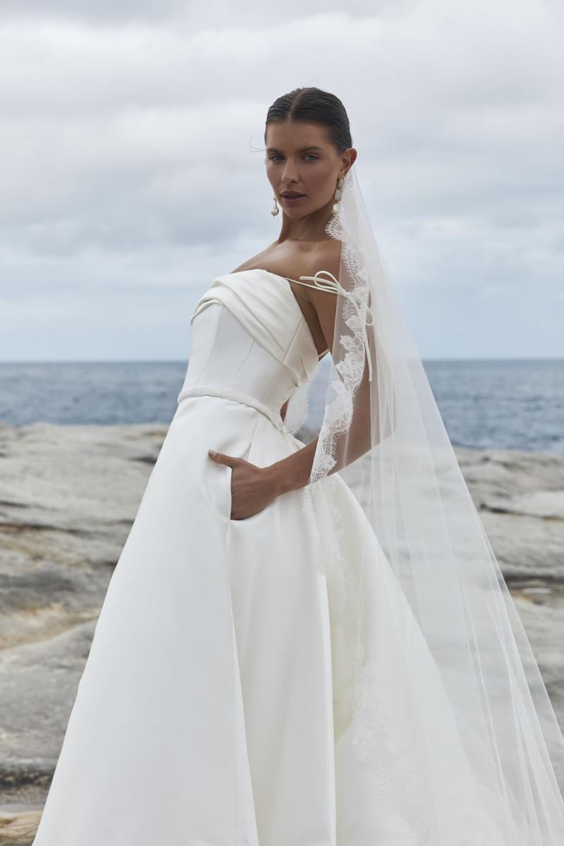 The Rosalind & Amelia wedding dress from KWH Bridal - Karen Willis Holmes - Straight neckline strapless bodice with draped detail paired with A-line Mikado skirt with dramatic wedding train