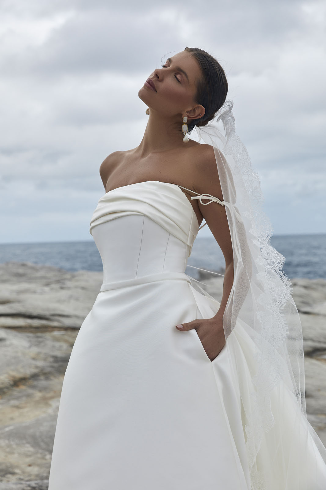 The Rosalind & Amelia wedding dress from KWH Bridal - Karen Willis Holmes - Straight neckline strapless bodice with draped detail paired with A-line Mikado skirt with dramatic wedding train