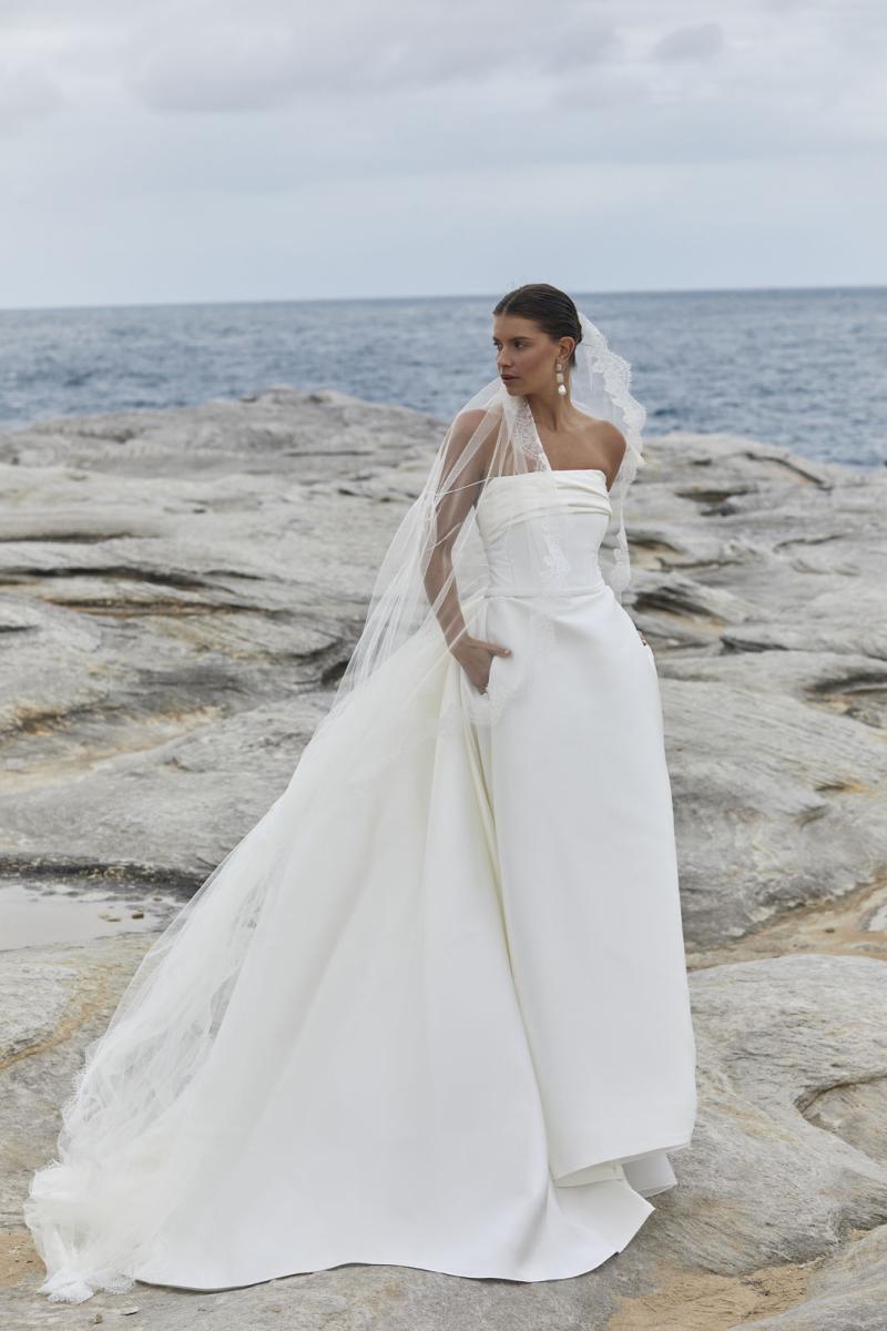 The Rosalind & Amelia wedding dress from KWH Bridal - Karen Willis Holmes - Straight neckline strapless bodice with draped detail paired with A-line Mikado skirt with dramatic wedding train