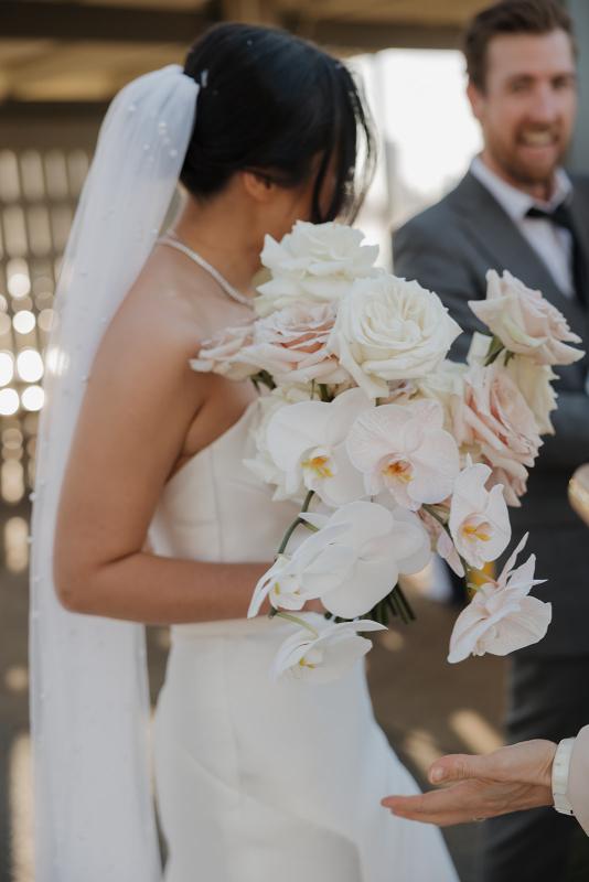 The Lou-Lou & Betsy wedding dress by KWH Bridal is a corset strapless draped gown with side split skirt detail for the modern minimal sexy bride