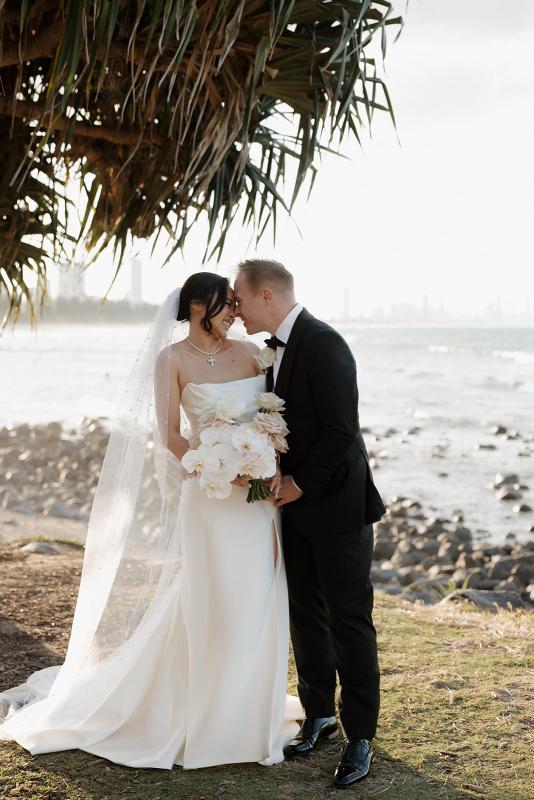 The Lou-Lou & Betsy wedding dress by KWH Bridal is a corset strapless draped gown with side split skirt detail for the modern minimal sexy bride