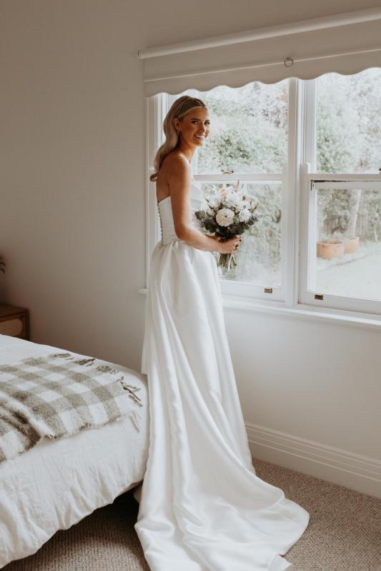 Emily wears the Lou Lou Dip gown from the Bespoke collection.