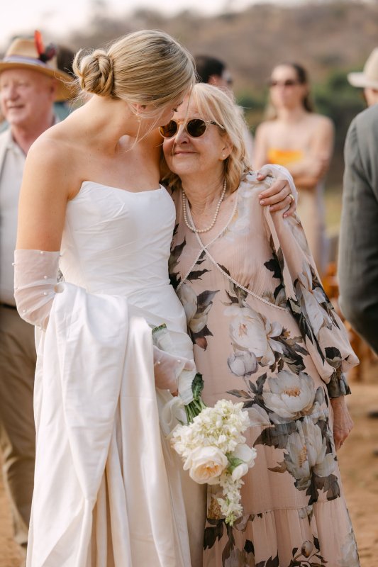 Rebecca and her mom after the ceremony, Rebecca is wearing our Emma Gown.