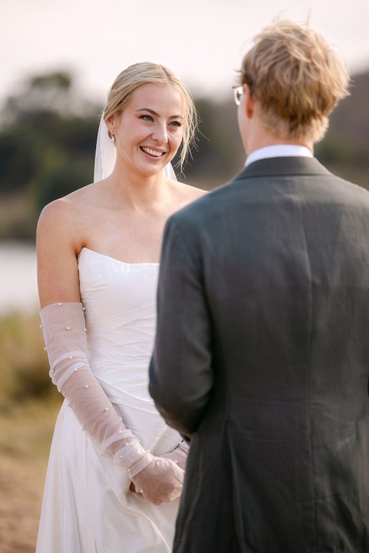 Rebecca and Blair during the ceremony. Rebecca is wearing our Emma Gown