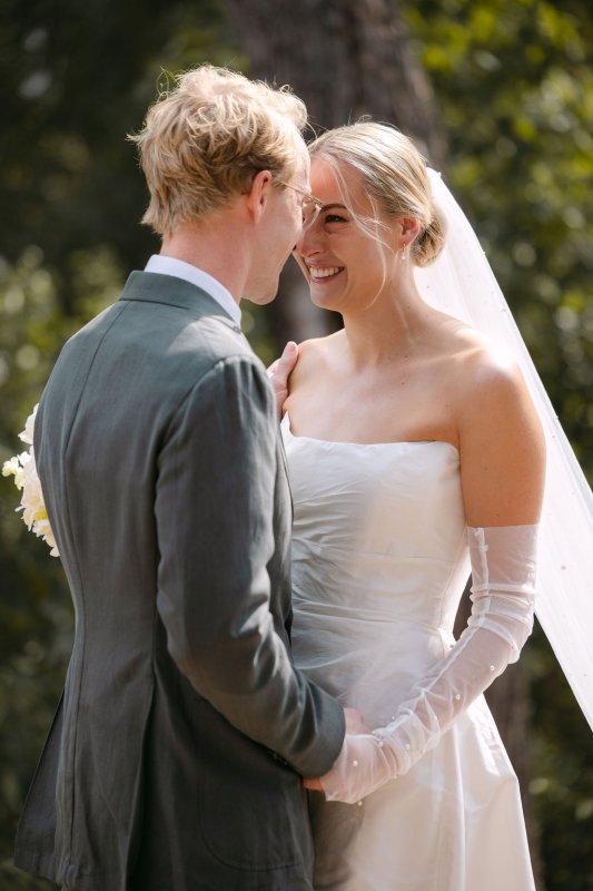 Rebecca and Blair during the ceremony. Rebecca is wearing our Emma Gown