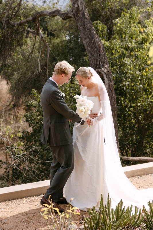 Rebecca and Blair during the ceremony. Rebecca is wearing our Emma Gown